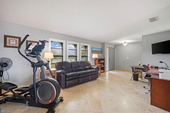 Living room currently used as office and for exercise.