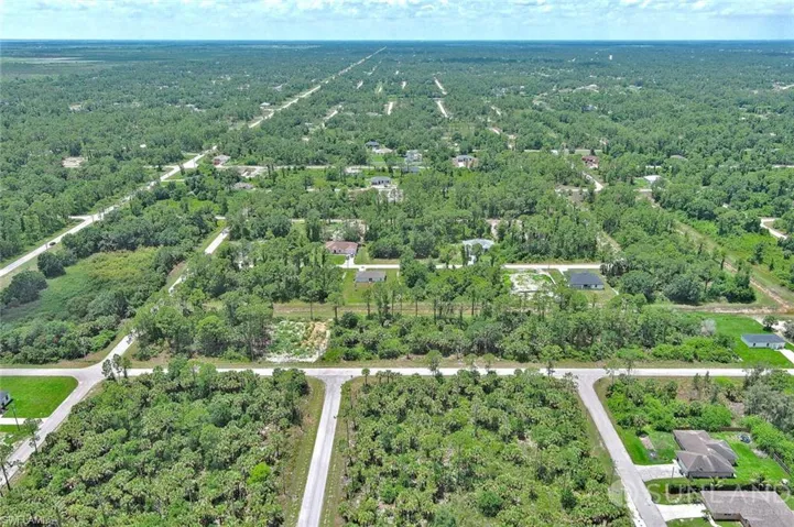 Aerial overview of property's location featuring a forest