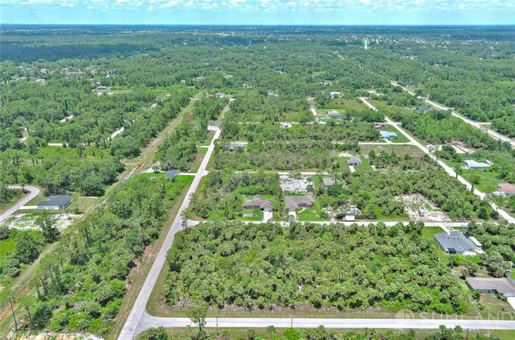 Aerial overview of property's location with a tree filled landscape