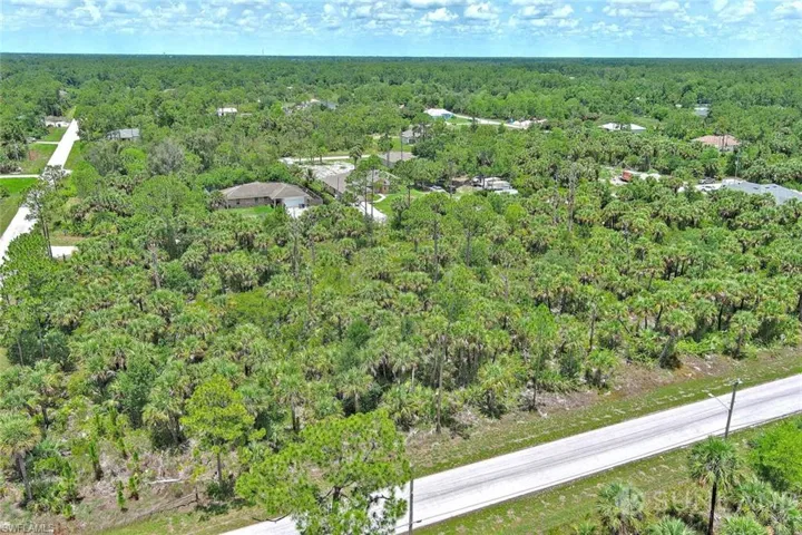 Aerial overview of property's location with a heavily wooded area