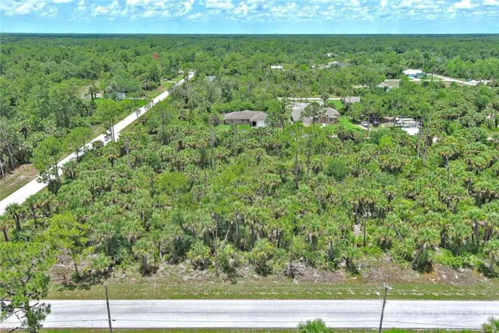 Aerial overview of property's location featuring a heavily wooded area