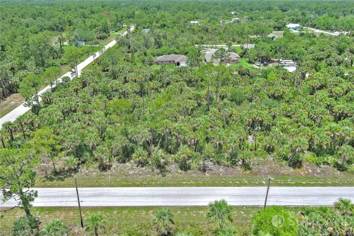 View of property location featuring a heavily wooded area