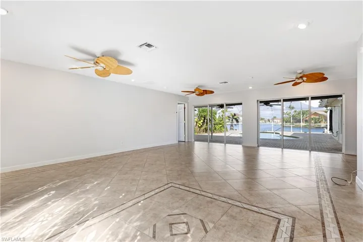 Spare room featuring a ceiling fan, recessed lighting, visible vents, and baseboards