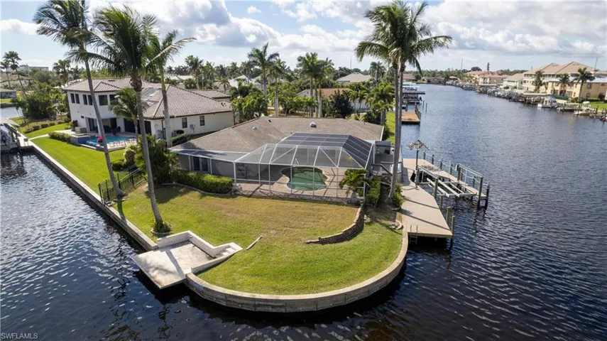 Birds eye view of property with a water view and a residential view