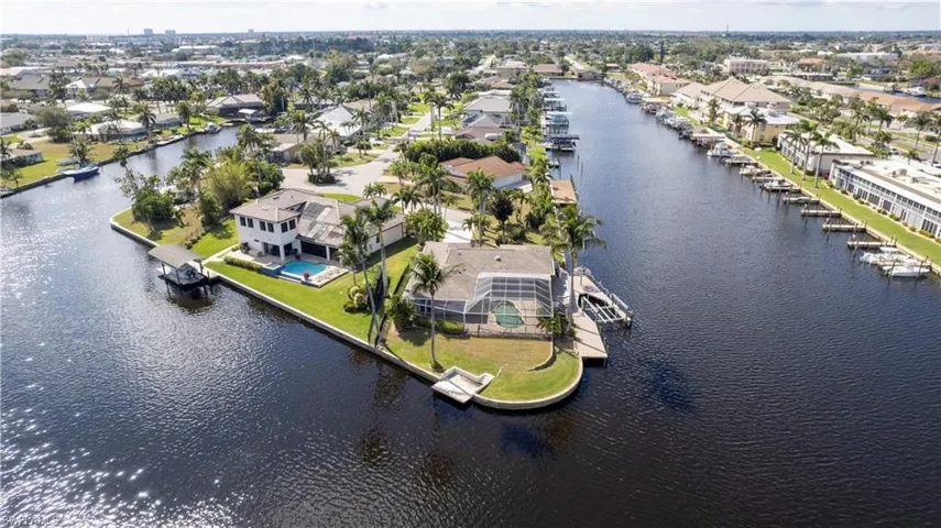 Birds eye view of property with a water view and a residential view