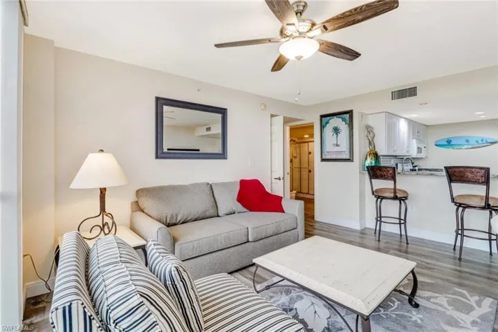 Living area with light wood finished floors and ceiling fan