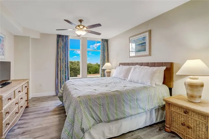 Bedroom with wood finished floors and ceiling fan