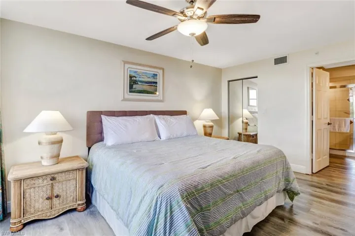 Bedroom featuring light wood finished floors, a ceiling fan, and a closet