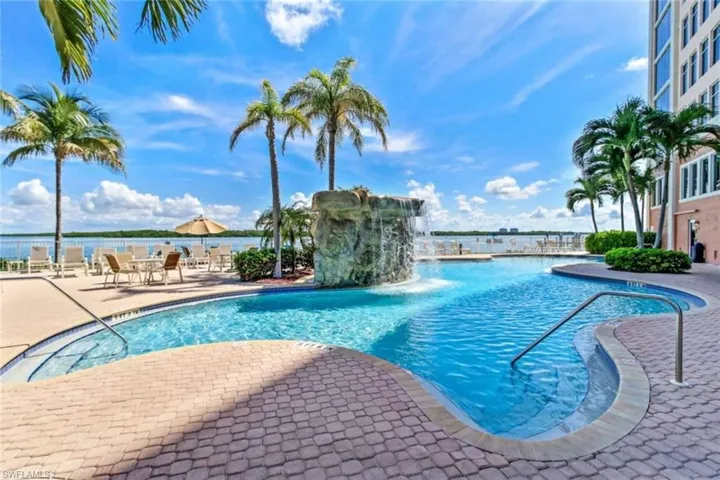 Community pool featuring a patio and a water view
