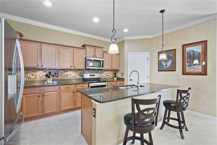 Stainless appliances, large island, and walk in pantry.