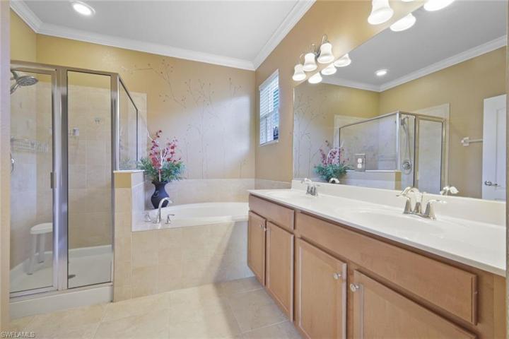En suite primary bath with dual sinks.
