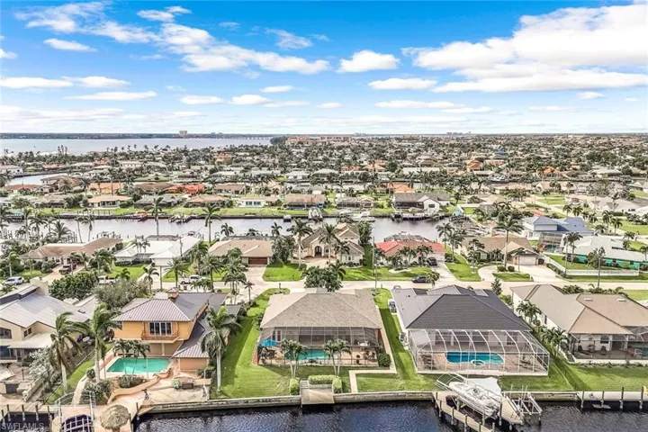 Birds eye view of property with a water view