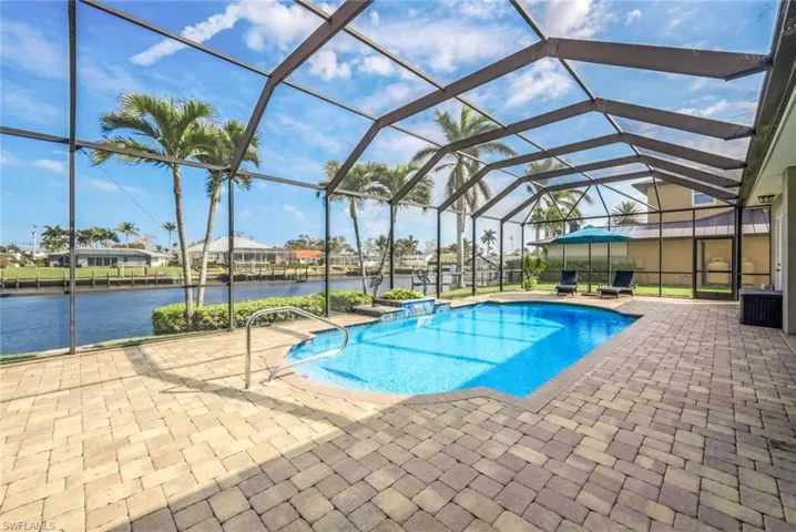View of pool featuring a water view, oversize paver pool deck