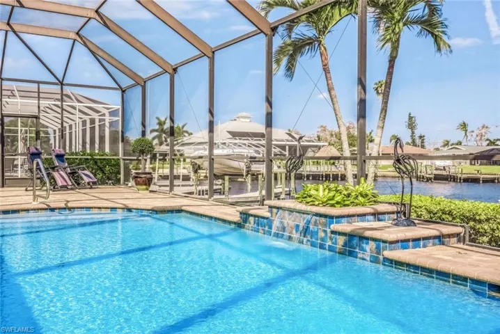 View of swimming pool, waterfall, and Direct Sailboat Unrestricted access almost 200' wide canal