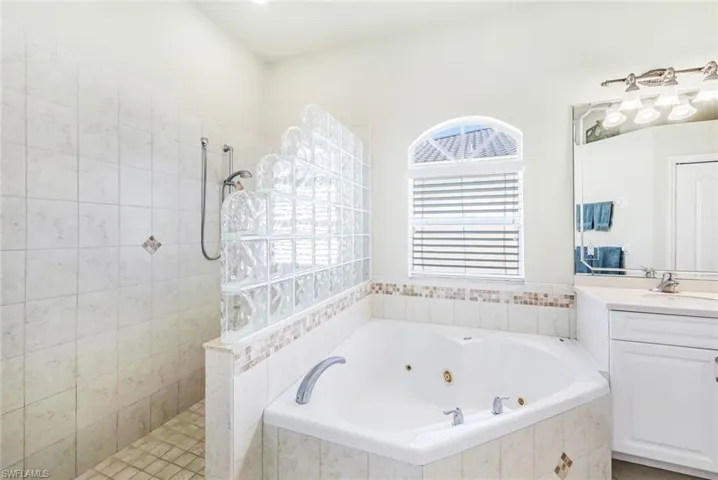 Primary Bathroom with vanity and shower with separate bathtub