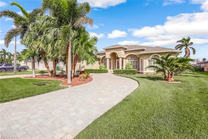 Circular paver drive and lush landscaping