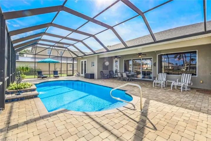 View of swimming pool with area, a lanai, oversize pool deck