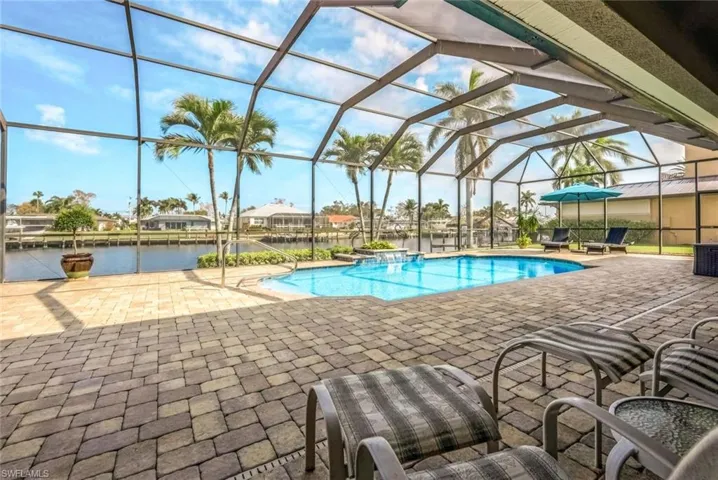 View of swimming pool, oversize pool deck and lanai