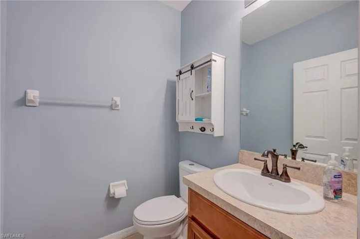 Half bath featuring vanity and toilet