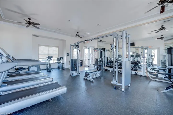 Exercise room featuring a ceiling fan and crown molding