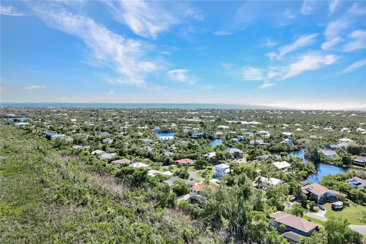 Aerial view of residential area featuring a large body of water