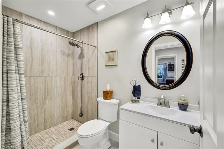 Full bathroom featuring a tile shower and vanity