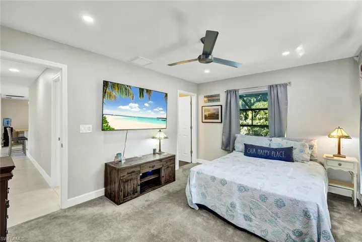 Bedroom with carpet flooring, ceiling fan, and recessed lighting