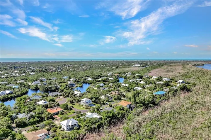 Aerial view of residential area featuring a large body of water