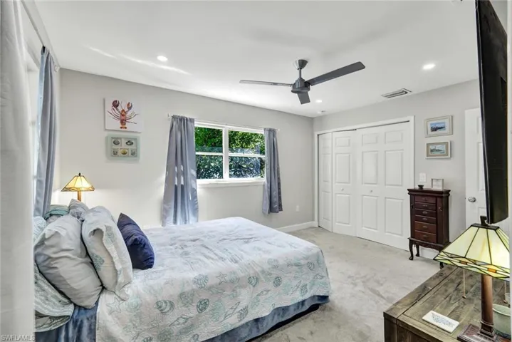 Bedroom with carpet, a closet, ceiling fan, and recessed lighting