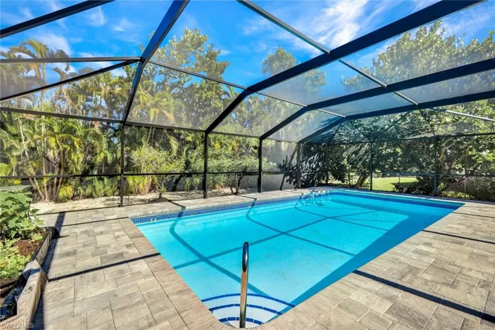 Outdoor pool featuring a lanai and a sunroom