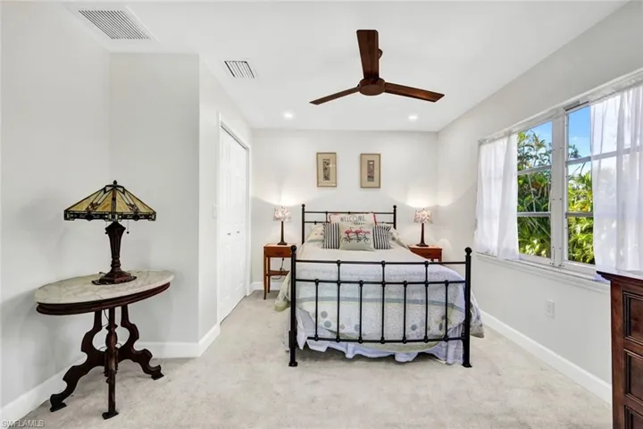 Bedroom with light colored carpet, a closet, a ceiling fan, and recessed lighting