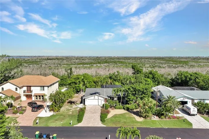 Aerial view of property and surrounding area featuring a heavily wooded area