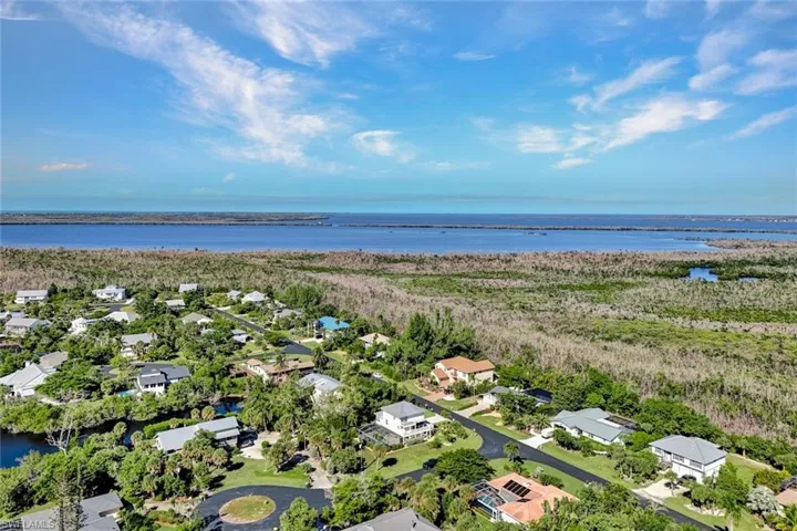Aerial view of residential area featuring a nearby body of water