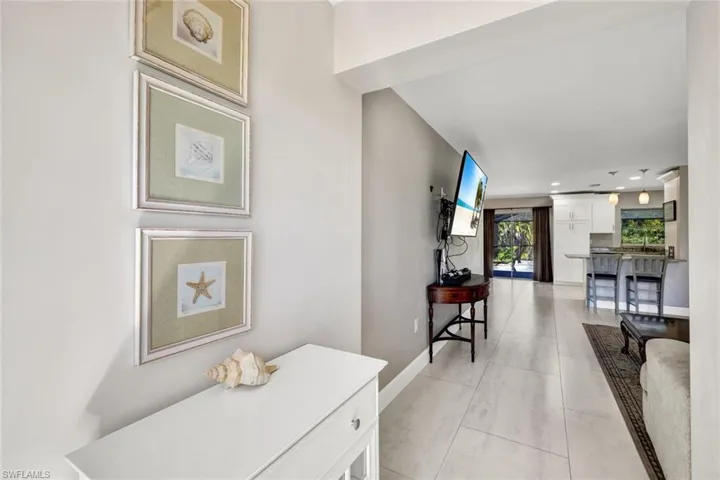 Hall featuring recessed lighting and light tile patterned floors