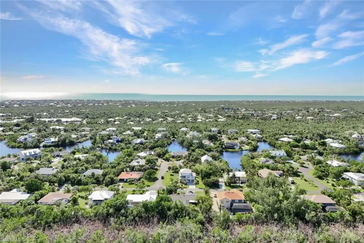 Aerial perspective of suburban area with a nearby body of water