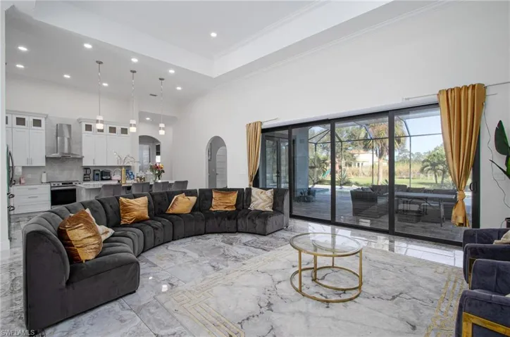Living room with a high ceiling and ornamental molding
