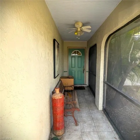 View of exterior entry with ceiling fan