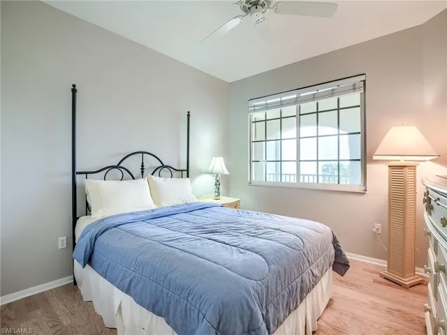 Bedroom with light wood-style flooring and a ceiling fan