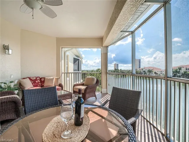 Balcony with a ceiling fan and a water view