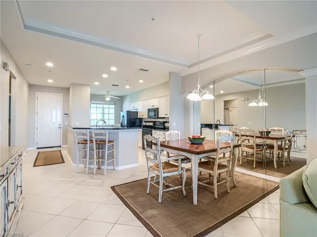 Dining room with light tile patterned floors, recessed lighting, crown molding, a chandelier, and arched walkways