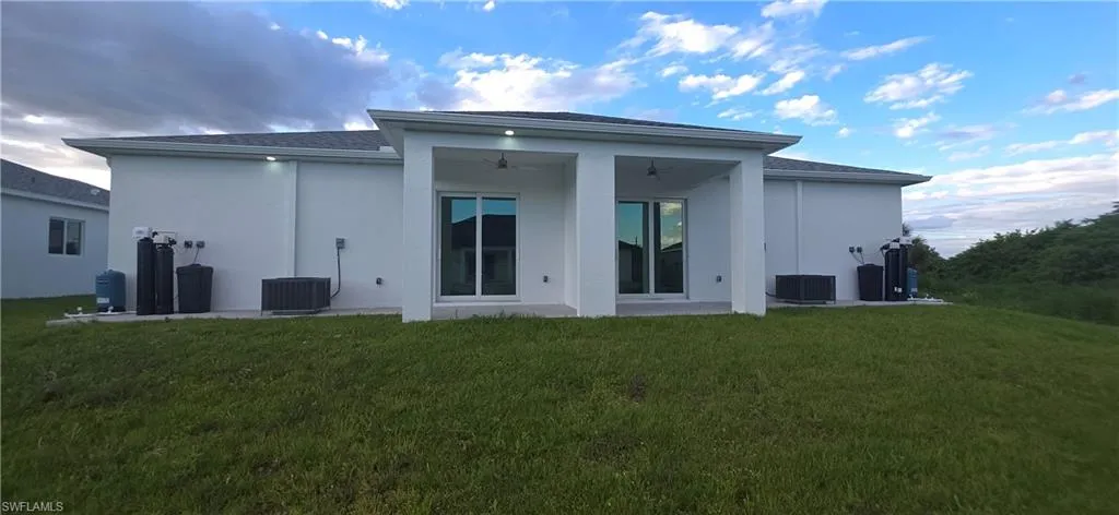 White stucco exterior with a covered patio featuring recessed lighting