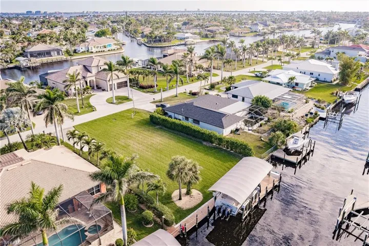 Birds eye view of property with a water view