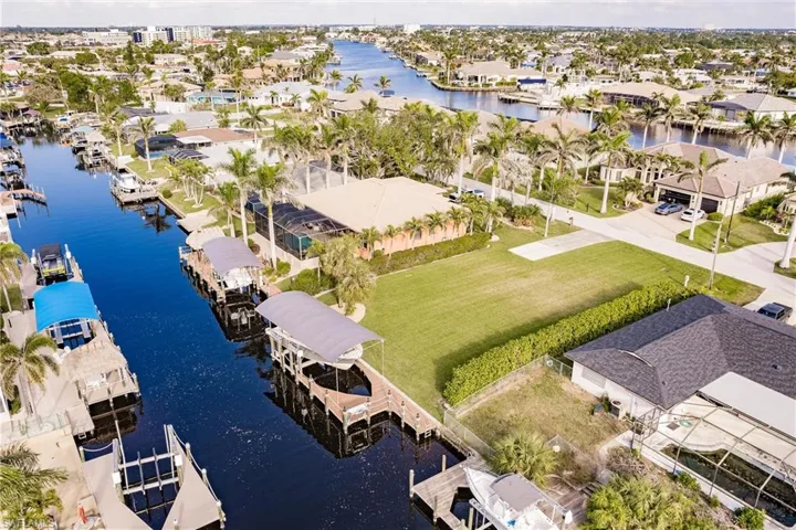Birds eye view of property with a water view