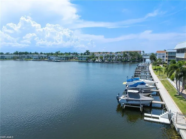 Water view with boat lift and a dock