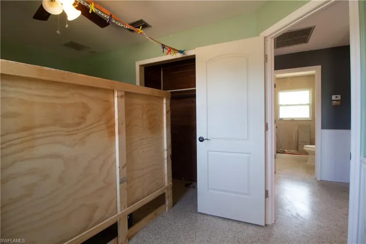 Unfurnished bedroom featuring a closet and visible vents