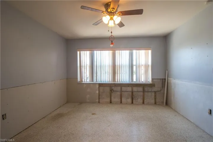 Unfurnished room featuring ceiling fan