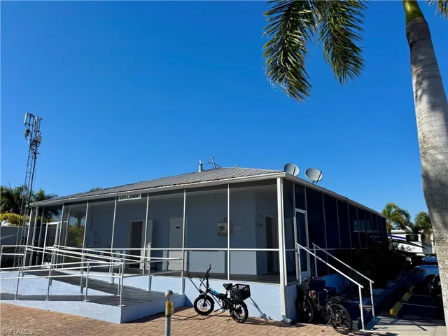 View of side of home featuring a metal roof and a sunroom