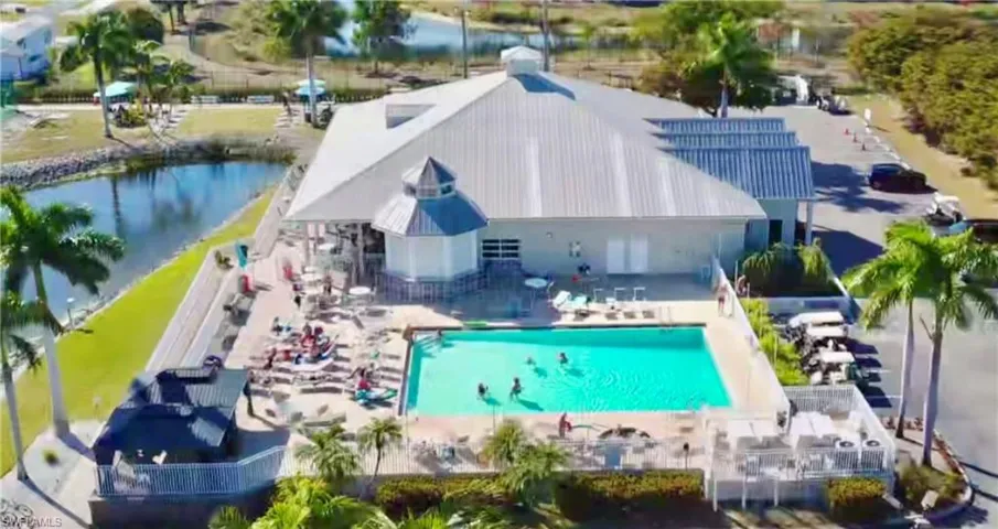 Drone / aerial view of a pool and a nearby body of water