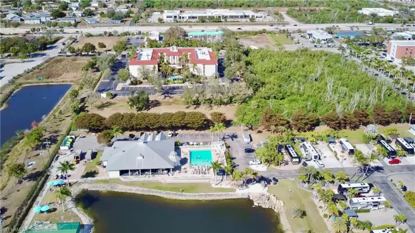 Aerial view of property's location with a nearby body of water and a pool