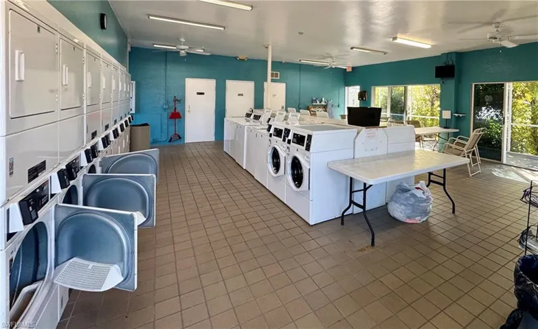 Shared laundry with a ceiling fan, washing machine and dryer, and stacked washing machine and dryer